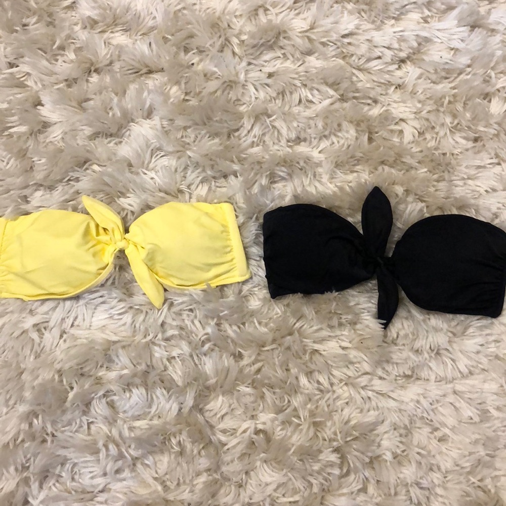 Two Victoria Secret strapless bathing suit tops.